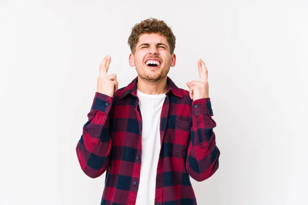 Young Blond Curly Hair Caucasian Man Isolated Crossing Fingers Having — Stock Photo, Image