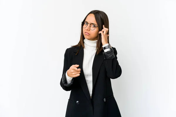 Young mixed race business woman isolated on white background pointing temple with finger, thinking, focused on a task.