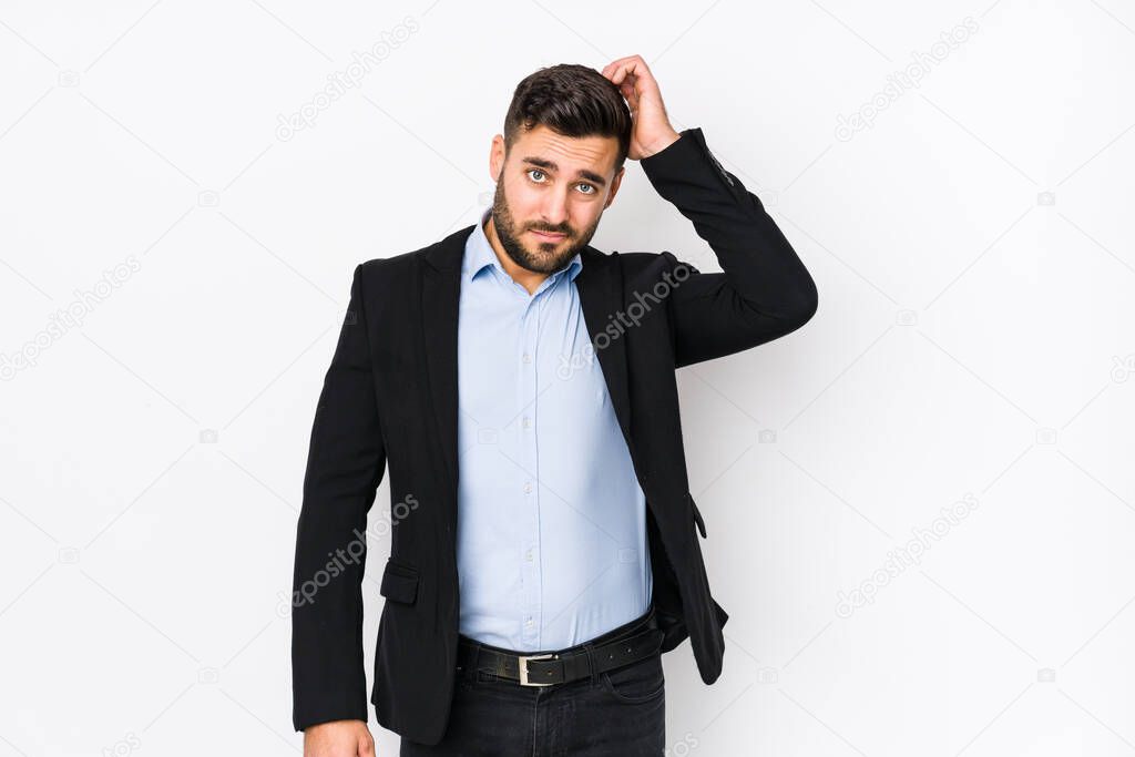 Young caucasian business man against a white background isolated being shocked, she has remembered important meeting.