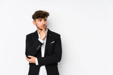 Genç Arap iş adamı şüpheli ve şüpheci bir ifadeyle yana bakıyor..