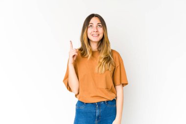 Beyaz arka planda izole edilmiş genç beyaz kadın iki parmağı da boş bir alan gösteriyor..