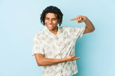 Genç Afrikalı Amerikalı Rasta adam işaret parmaklarıyla küçük bir şey tutuyor, gülümsüyor ve kendinden emin..