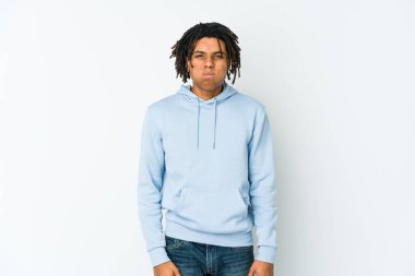 Genç Afrikalı Amerikalı Rasta adamın yanakları şişiyor, yorgun bir ifadesi var. Yüz ifadesi kavramı.