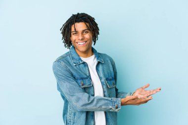 Kot ceket giyen genç siyahi bir adam avucunun içinde fotokopi odası tutuyor..