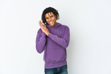 Genç Afro-Amerikan Rasta adamı enerjik ve rahat hissediyor, ellerini ovuşturup kendinden emin.