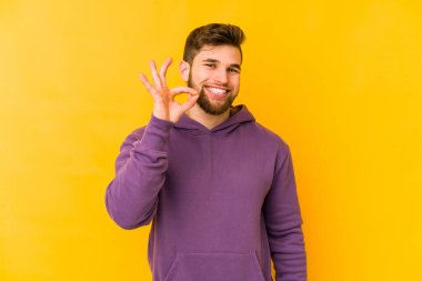 Genç beyaz adam sarı arka planda izole edilmiş neşeli ve kendinden emin..