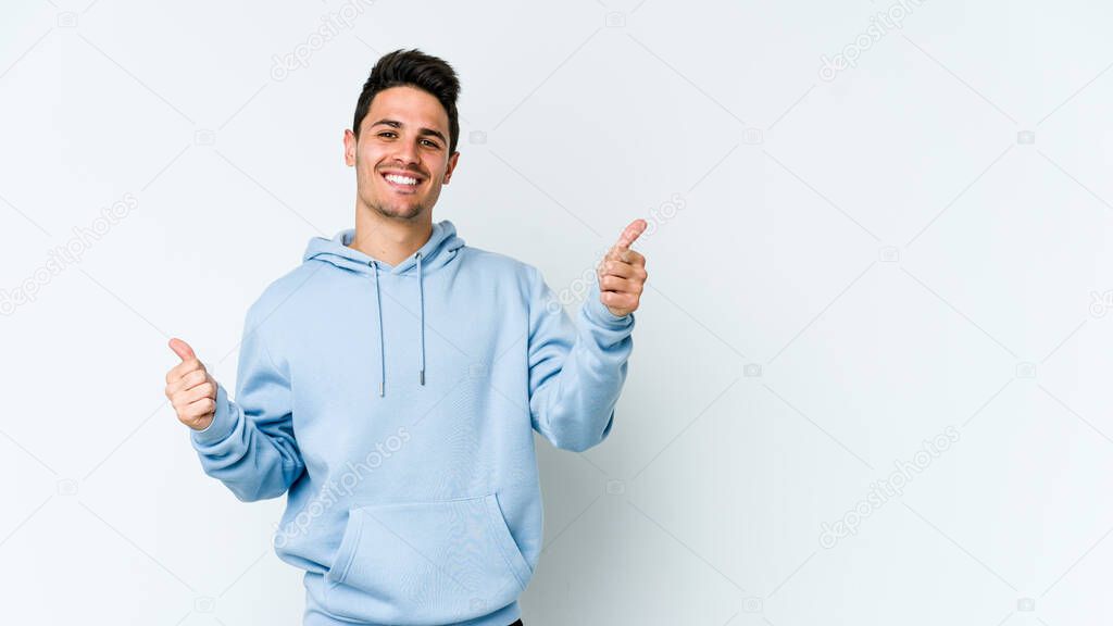 Young caucasian man isolated on white background raising both thumbs up, smiling and confident.