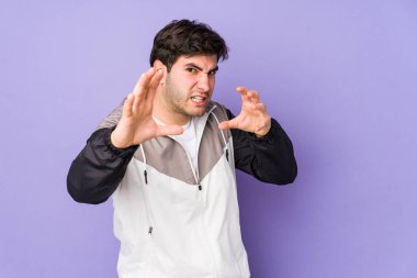Mor arka planda izole olmuş genç adam gergin ellerle çığlık atıyor..