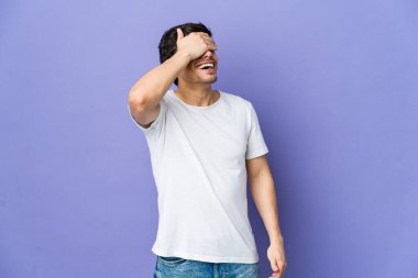 Genç havalı adam ellerini başının üstünde tutarak neşeyle güler. Mutluluk kavramı.