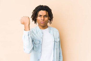 Genç Afrikalı Amerikalı Rasta adam kameraya yumruğunu gösteriyor, agresif yüz ifadesi..