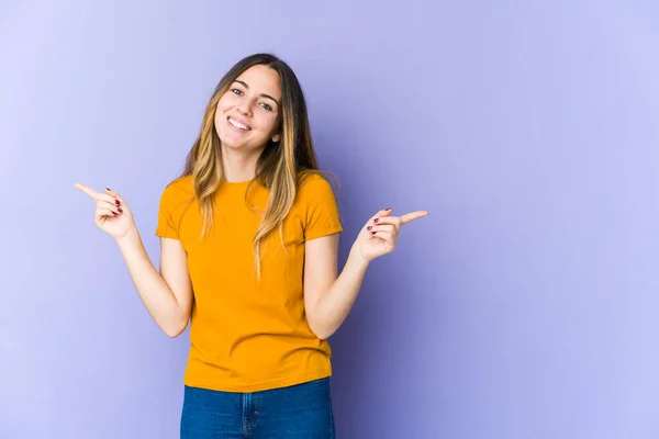 Giovane Donna Caucasica Isolata Sfondo Viola Che Punta Diversi Spazi — Foto Stock