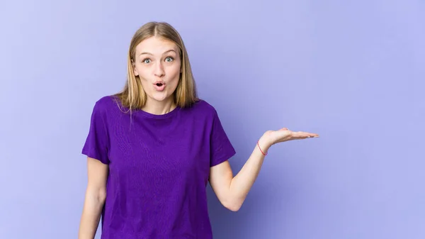 Young Blonde Woman Isolated Purple Background Impressed Holding Copy Space — Stock Photo, Image