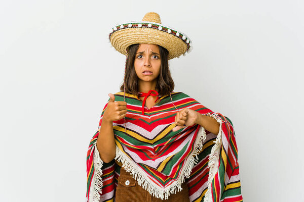 Young mexican woman isolated on white background showing thumbs up and thumbs down, difficult choose concept