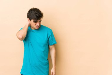 Stres yüzünden boynu ağrıyan, masaj yapan ve elle dokunan genç havalı bir adam..