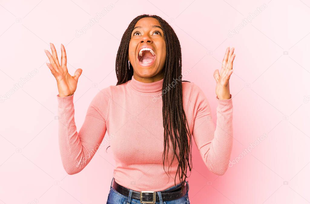 Young african american woman isolated on a pink background screaming to the sky, looking up, frustrated.