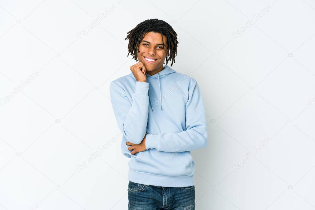 Young african american rasta man smiling happy and confident, touching chin with hand.