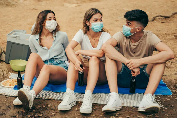 Friends in masks enjoying a summer day in a 2020 pandemic.