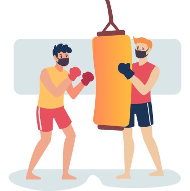 Maskeli boksörler kum torbasını birlikte kullanarak boks becerilerini geliştiriyorlar.