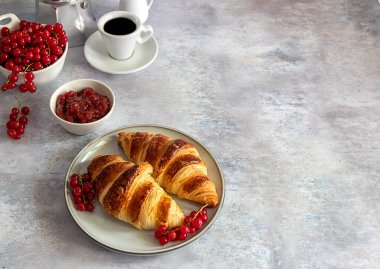 Taze tereyağlı kruvasan, böğürtlen, reçel ve kahve. Kahvaltı konsepti.