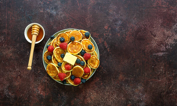 Family breakfast. Heap of mini cereal pancakes.