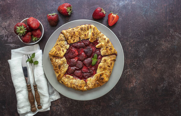 Galette with strawberries. Vegetarian healthy berry tart. Delicious summer food dessert. Copy space for recipe or text.