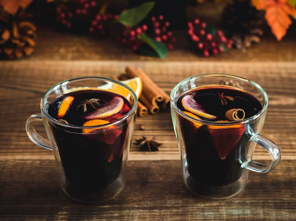 Cozy autumn drink with blurred background. Hot mulled wine with oranges and spices. seasonal warm alcohol beverage