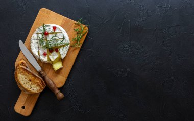 Ballı fırın peyniri, incir ve siyah zemin üzerinde taze ekmek. Üst görünüm, alanı kopyala.