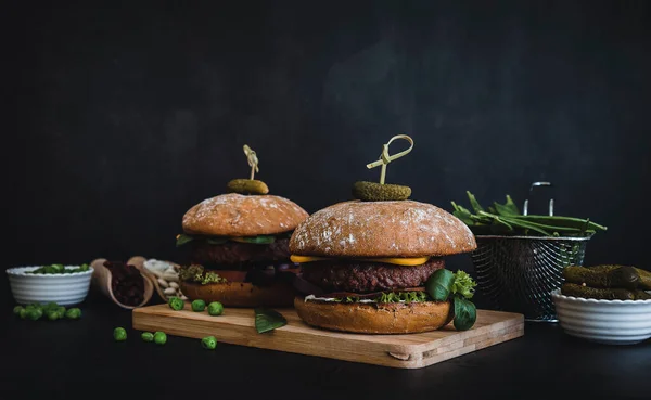 Vegan burger made of beans, beetroot, and peas. dark moody style.