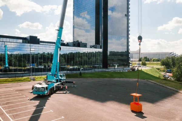 view from the height of the car of a heavy crane with a cradle, which is open in the Parking lot and ready to work. the highest truck crane is deployed on the site. the height of the boom is 80 meters.