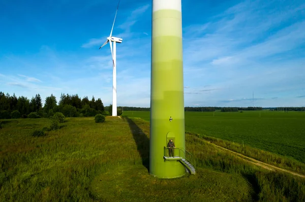 Man Business Suit Green Golf Shirt Stands Next Windmill Background — Stock Photo, Image