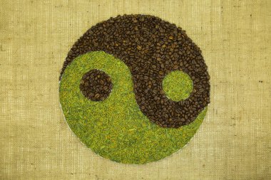 The concept of yin yang. Sign yin yang against the background of burlap. Japanese match tea with fried rice and Cuban coffee were used. clipart
