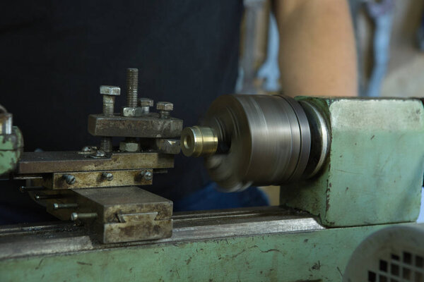 Working on a lathe. The machine is ready for work. The mechanism is at work.