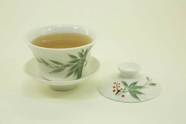 Ukrainian herbal tea. Herbal tea in a beautiful traditional oriental cup with saucer. Isolated in a white bowl on a white background.