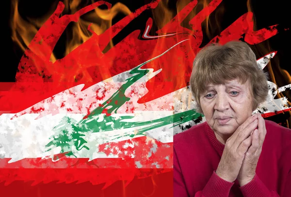 Explosion in Lebanon. Lebanese flag in front of fire. Portrait of a grieving woman