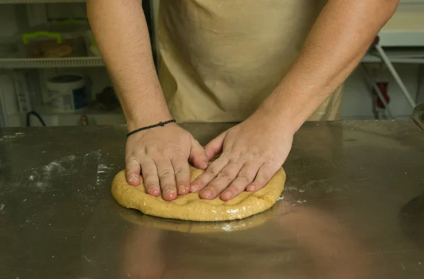 The process of making bread. The chef kneads the dough by hand.The dough is ready for baking. The chef prepares bread for baking.