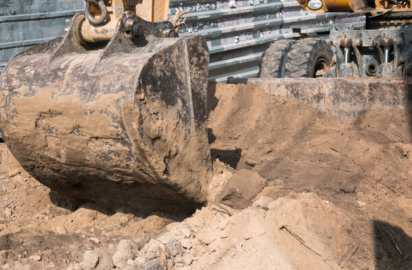 Construction of a new multi-storey building. Bucket excavator work when laying the foundation.