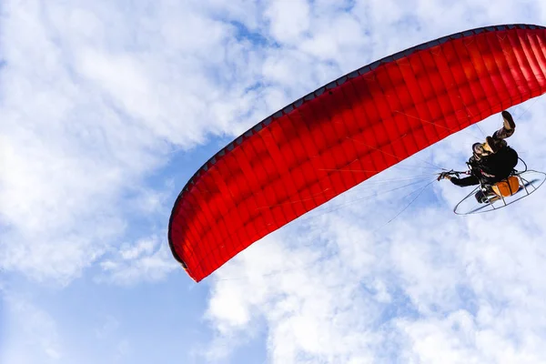 Motor paraglider vliegen in blauwe hemel met witte wolk op achtergrond. — Stockfoto