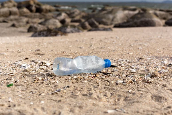 Milieu concept Prullenbak vervuiling van plastic fles op het strand. — Stockfoto