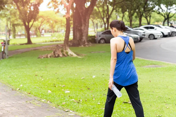 Mulher mão segurando garrafa de água andando no parque no ummer . — Fotografia de Stock