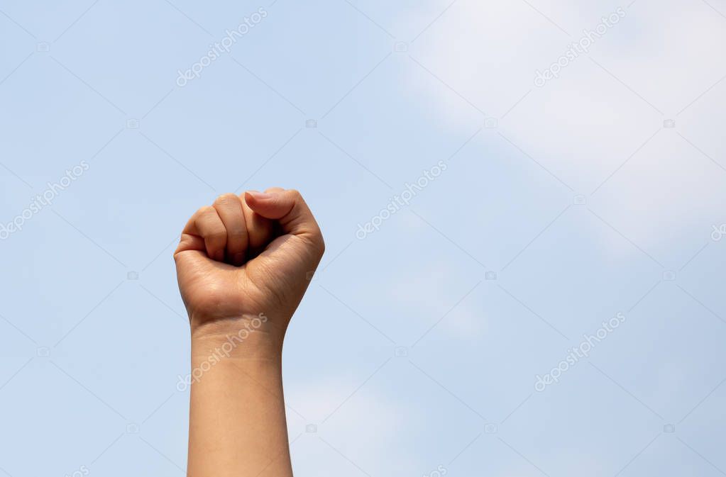 Woman arm with fist raised in the air