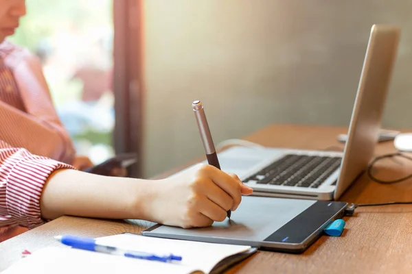 Graphic designer using digital tablet with laptop on the desk. — Stock Photo, Image