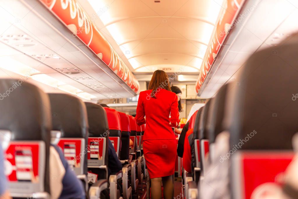 Flight attendant serve food and drinks to passengers on board.