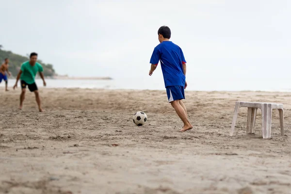 Selezionato focus group di amici che giocano a calcio sulla spiaggia in estate . — Foto Stock