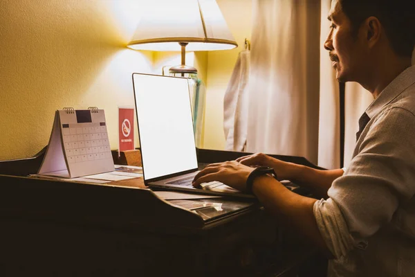 Businessman busy working on laptop in hotel room