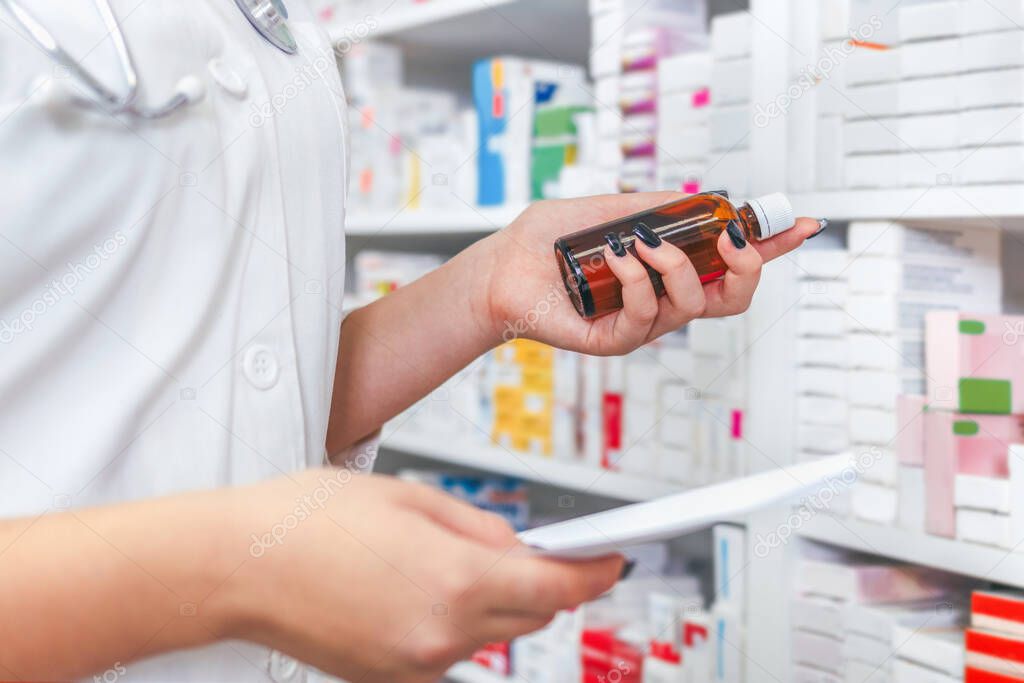Pharmacists searching for medication by prescription in drugstore