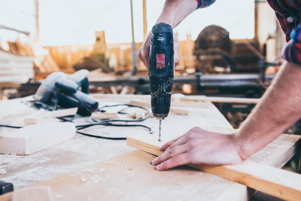 Carpenter At Work Using Hand Drill