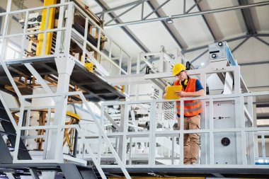 Fabrikadaki üretim hattı. Endüstriyel tesis veya kamu hizmetlerindeki ekipmanları kontrol eden veya ayarlayan teknisyen veya mühendis