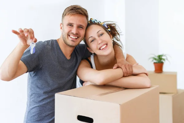 Couple showing keys of a new apartment. Moving in day