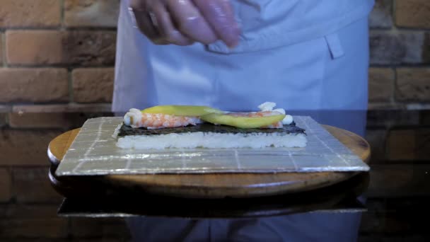 米巻き 寿司巻き料理のプロセス ロールには米 マンゴー エビが入っています おいしい料理 料理人は手袋をしている — ストック動画