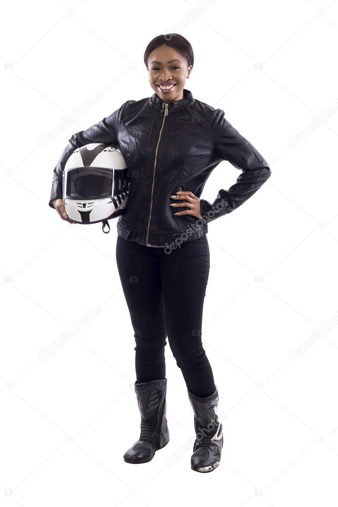 Confident strong black female holding a helmet as a race car driver, motorcycle biker or a stuntwoman.  The image depicts feminism by portraying a gritty woman of extreme motorsports.